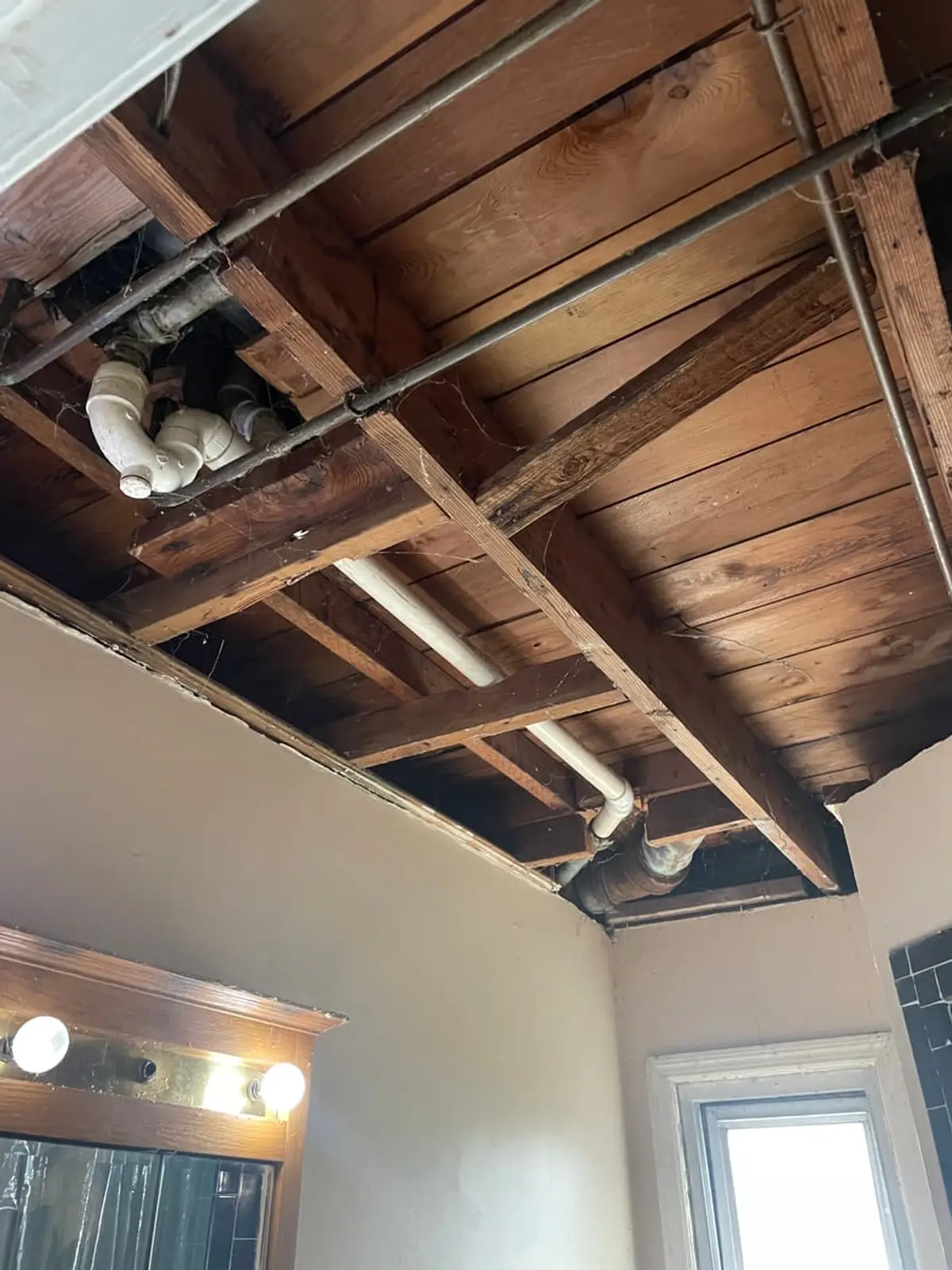 Selling a house in a flood zone in Massapequa: bathroom ceiling opened to the joists after a leak