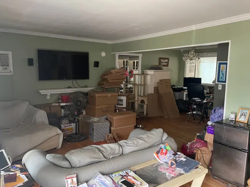 Living room with furniture and boxes stacked up, Massapequa, NY