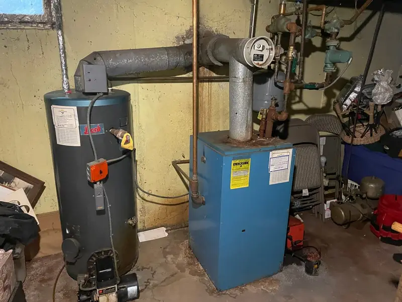 Old boiler and water heater in a basement, Massapequa, NY