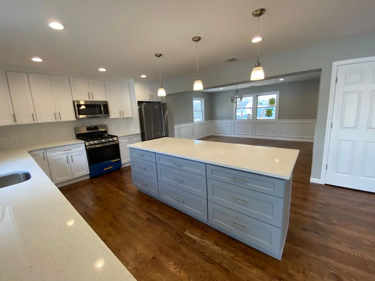 Selling a house with a reverse mortgage in Massapequa: renovated kitchen with white cabinets and a large island