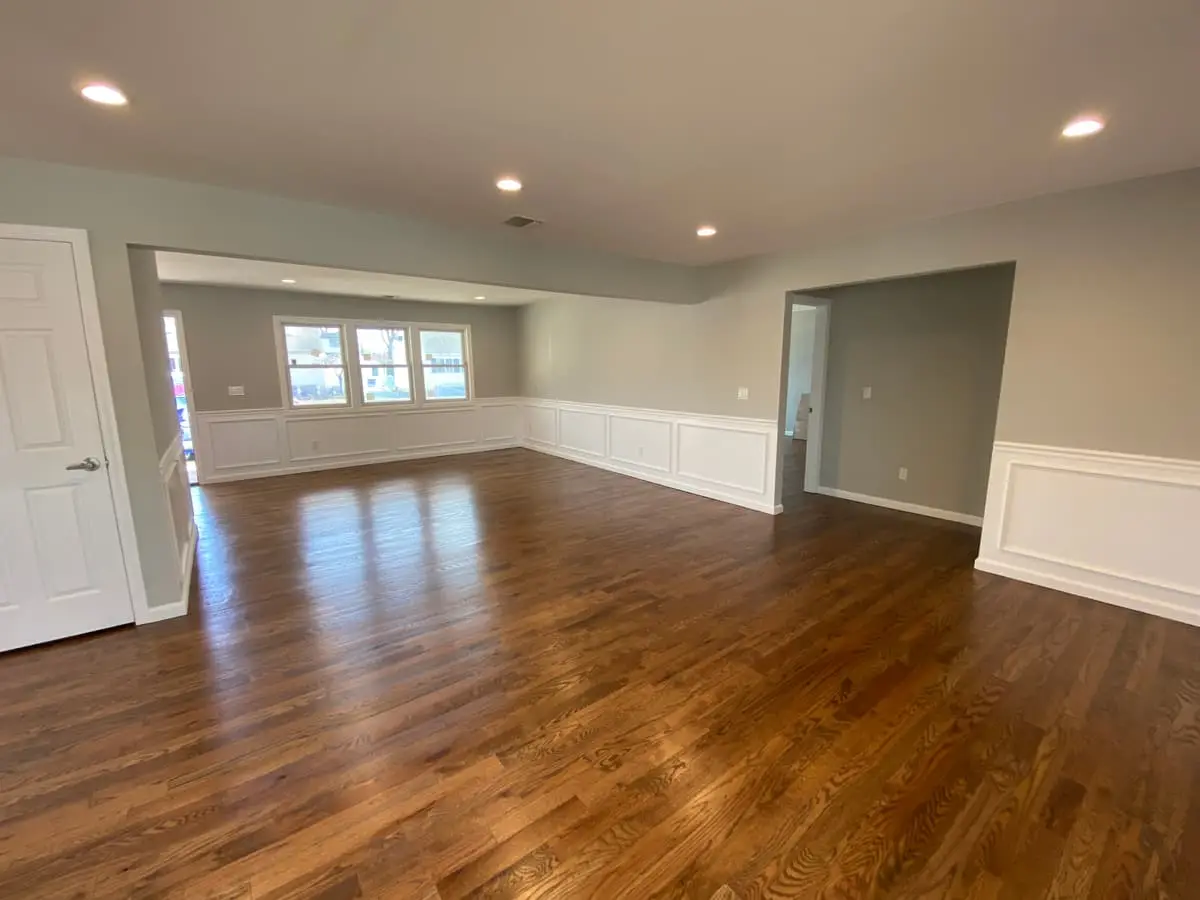 Wondering what your Massapequa house is worth: renovated open living space with wainscoting and wood floors