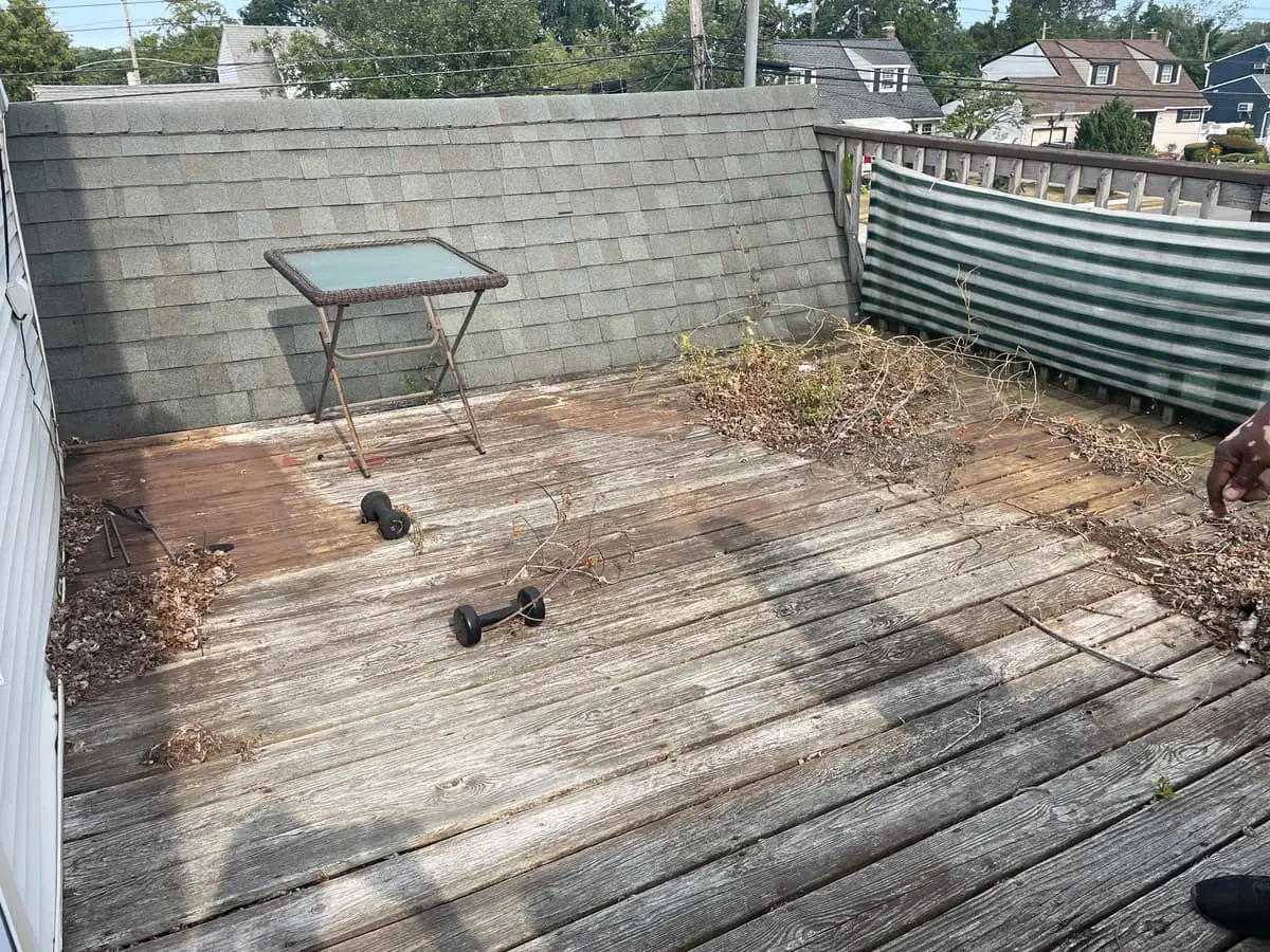 Selling a house as-is in Massapequa: weathered roof deck with stained boards